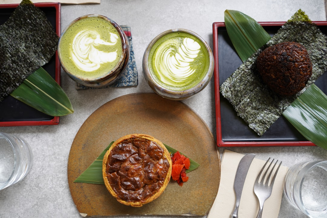 A customer examines her bowl of matcha kakigori, taking in the color of the seasonal dessert before the first spoonful.
