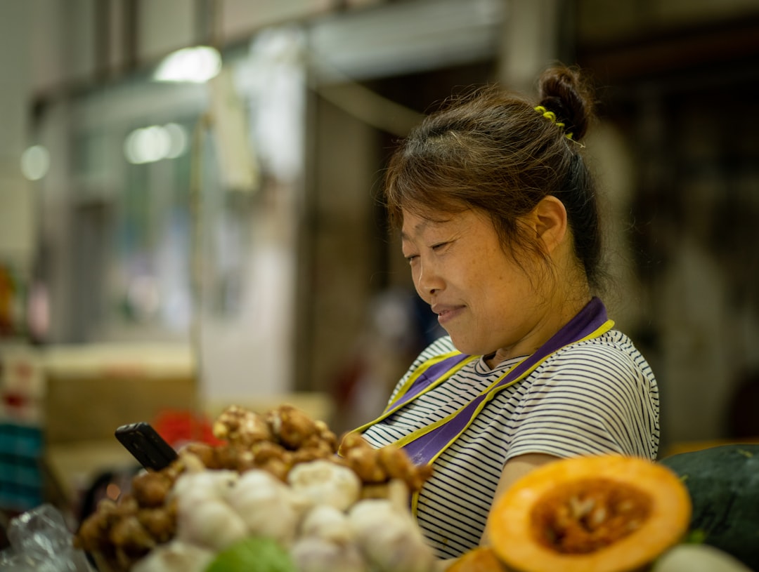 A shopper carefully selecting fresh sashimi trays at a Tokyo depachika basement food hall
