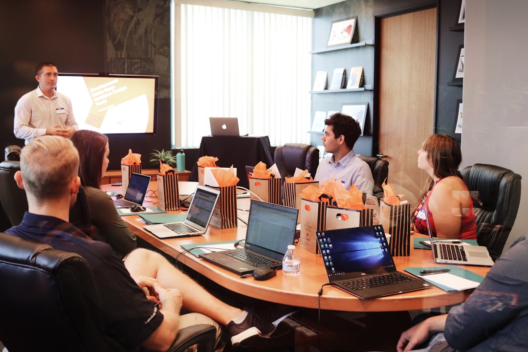 A professional woman presents strategy slides to colleagues at a Tokyo headquarters team meeting.