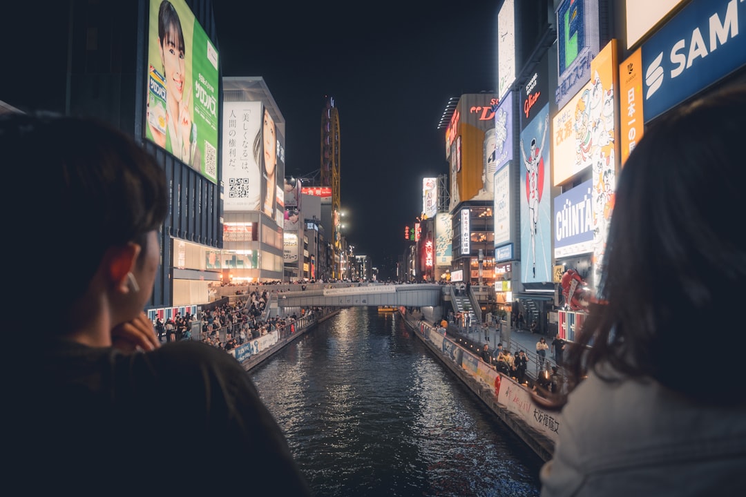 Spectators in yukata watching the hanabi festival over the Sumida River in Tokyo at night