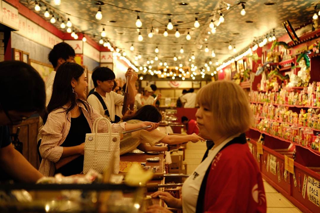 A gluten-free shopper exploring the ready-to-eat counters of a Tokyo depachika hall at closing hour