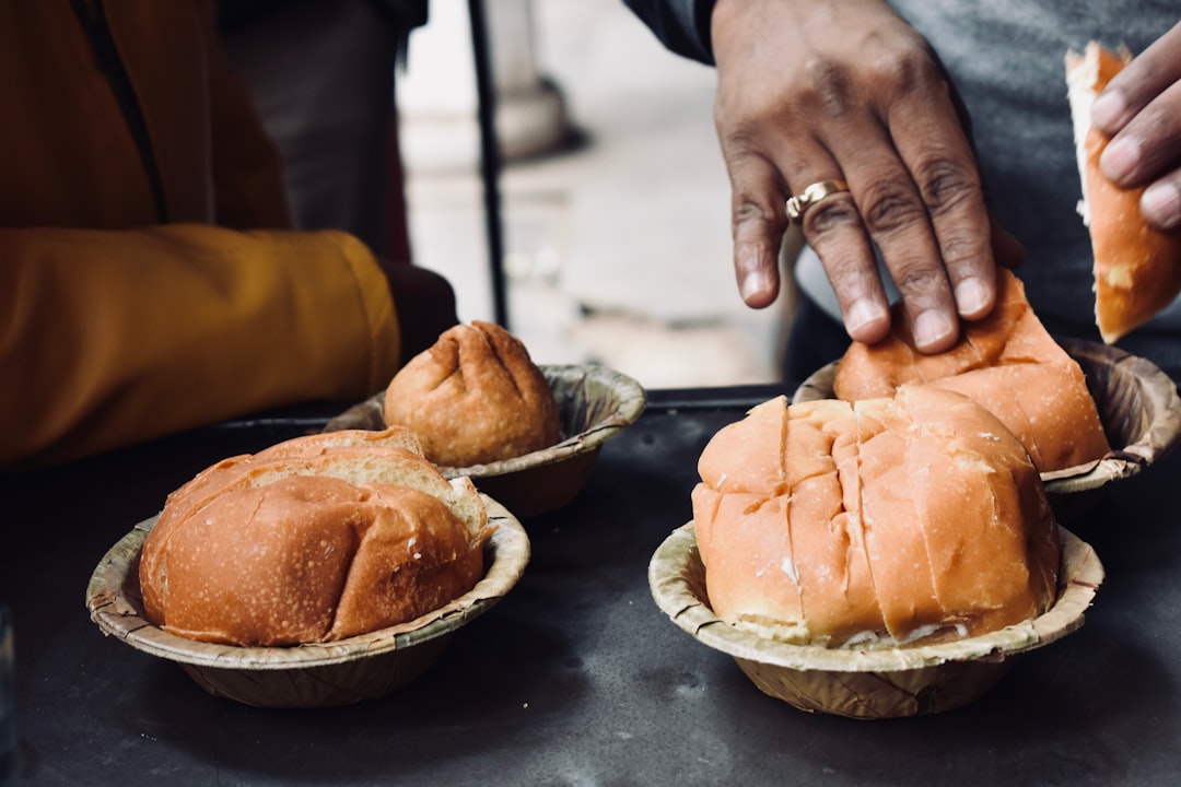 A person enjoys a freshly baked milk bread sweet bun at a traditional Tokyo bakery