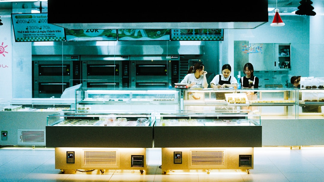 A woman chooses a milk bread loaf at a Japanese bakery counter in Tokyo, surrounded by fresh baked goods