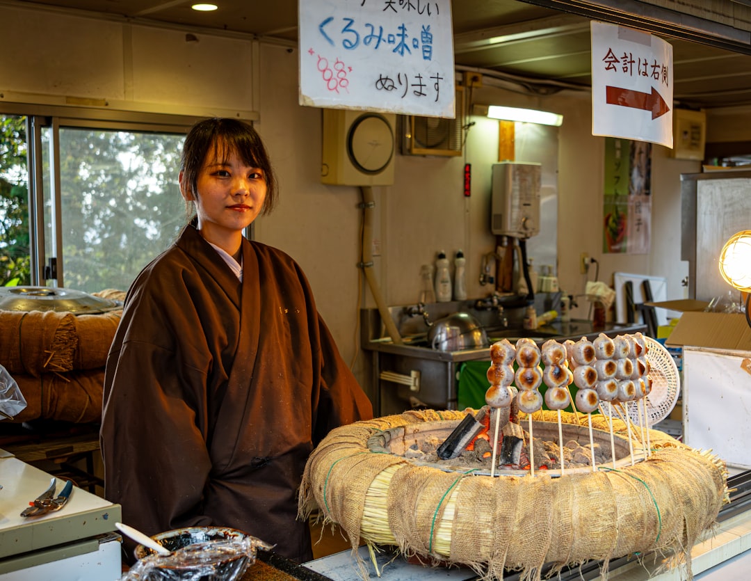 A woman examining beautifully packaged mochi wagashi at a Tokyo depachika counter