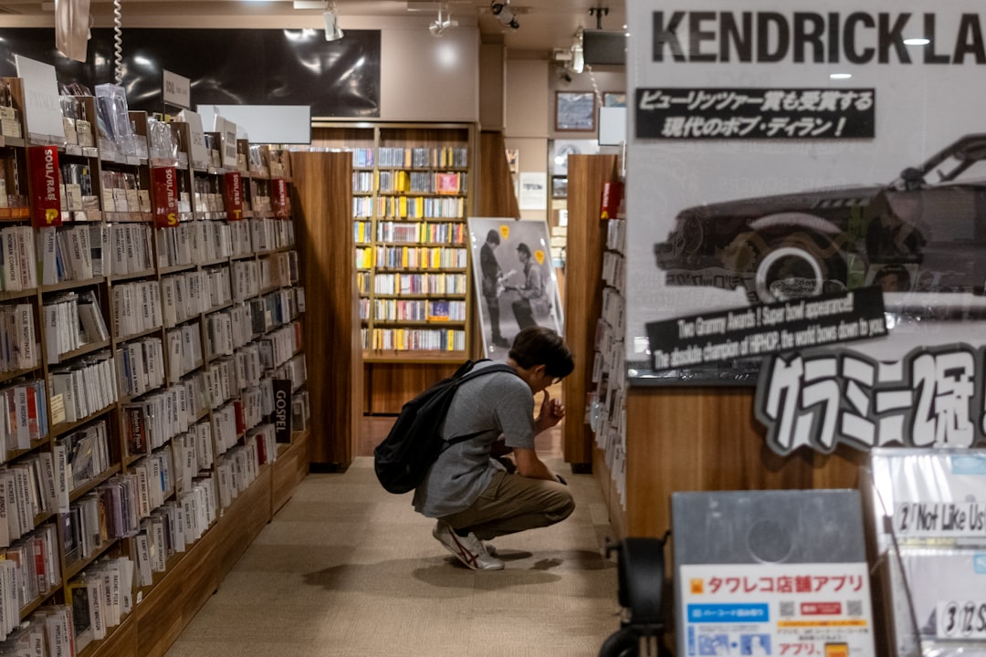 A woman sits quietly in a Tokyo listening bar, experiencing kissa culture through vinyl played on a hi-fi system
