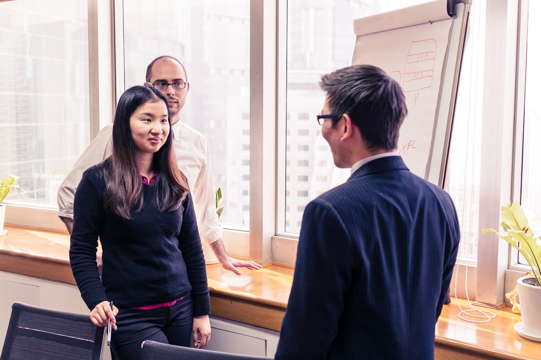 A foreign founder shaking hands with a Tokyo angel investor after a successful first meeting in a modern office