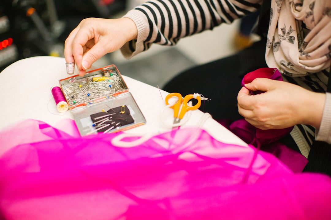 A volunteer helps a woman mend a jacket at a repair café in Tokyo, showing community mending in action.