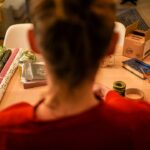 A woman in Tokyo carefully practising furoshiki wrapping with a patterned square textile