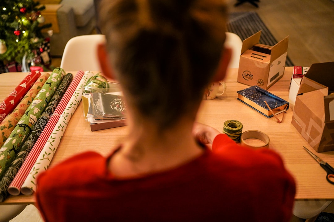 A woman in Tokyo carefully practising furoshiki wrapping with a patterned square textile
