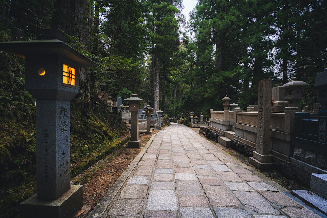 A family lights incense at a grave during the autumn equinox Ohigan observance in Tokyo's shitamachi district