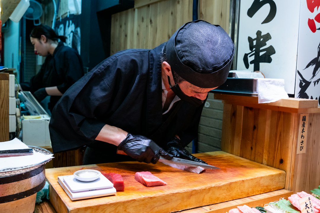 Sushi chef preparing saury nigiri during sanma season at Toyosu Market