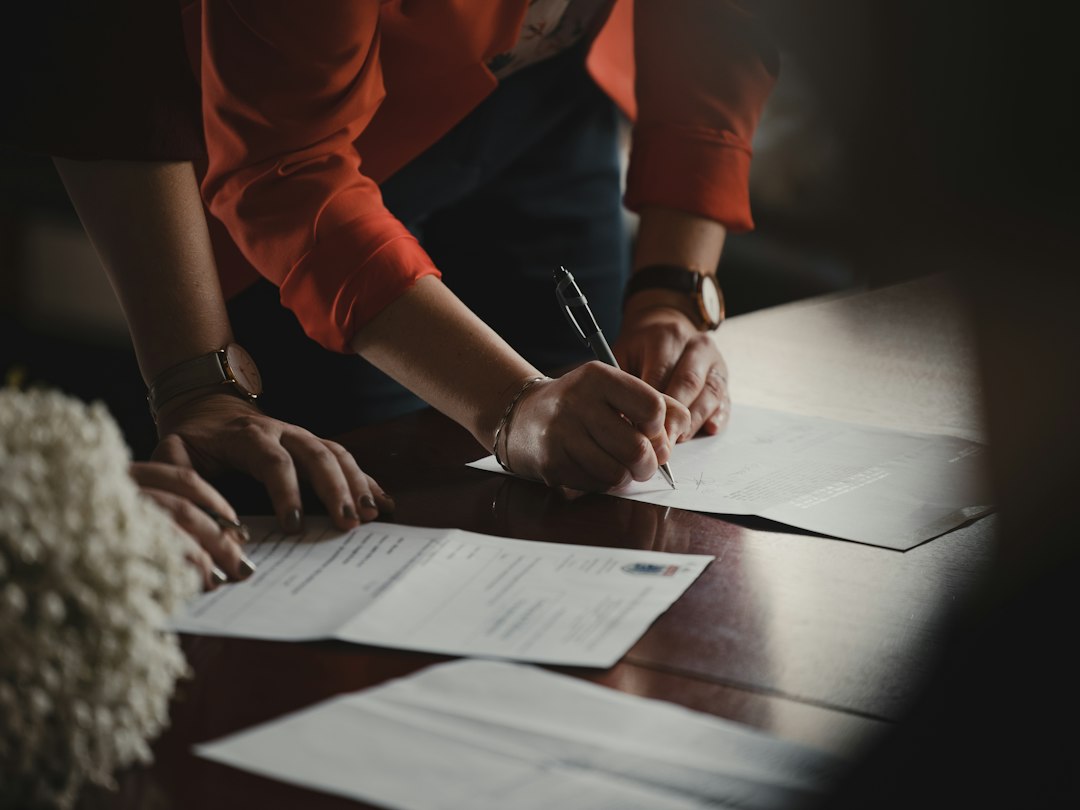 Foreign entrepreneur signing business account paperwork at a Tokyo bank branch